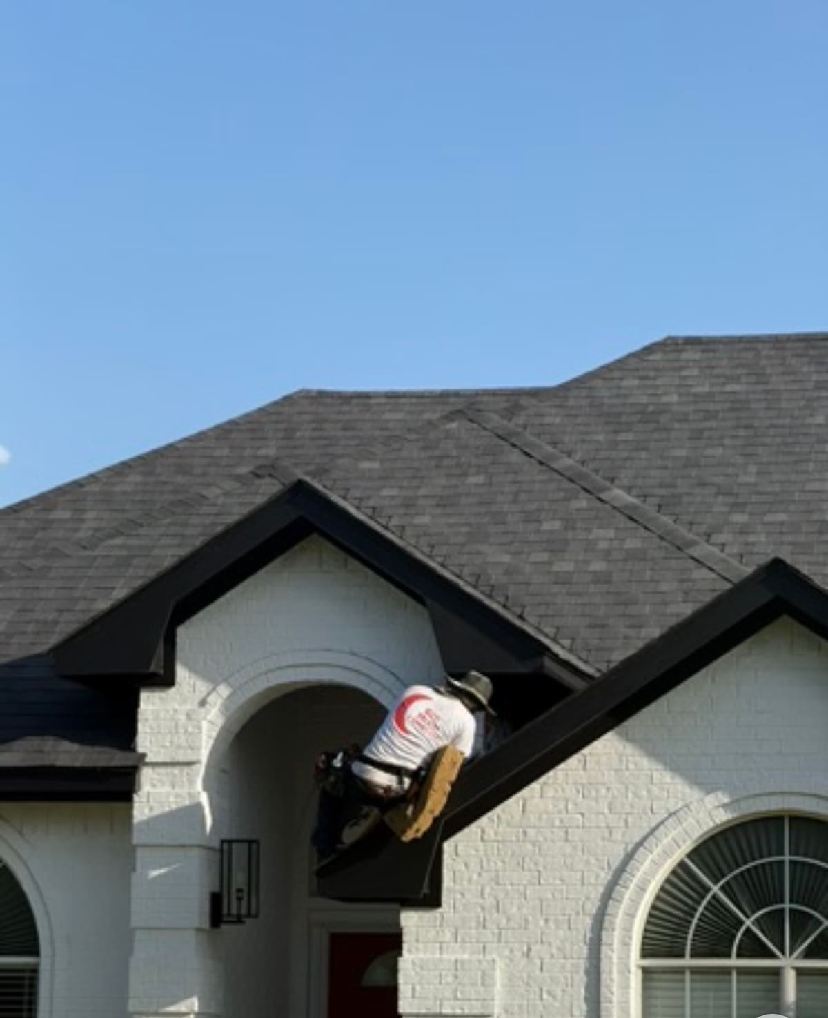 Red Moon Expert roofer working on a residential roof