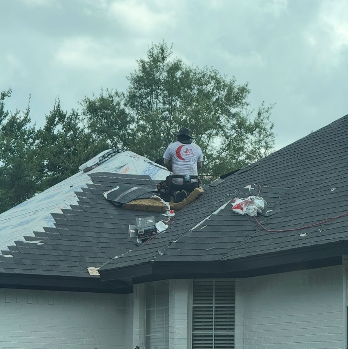 Red Moon Expert roofer working on a home