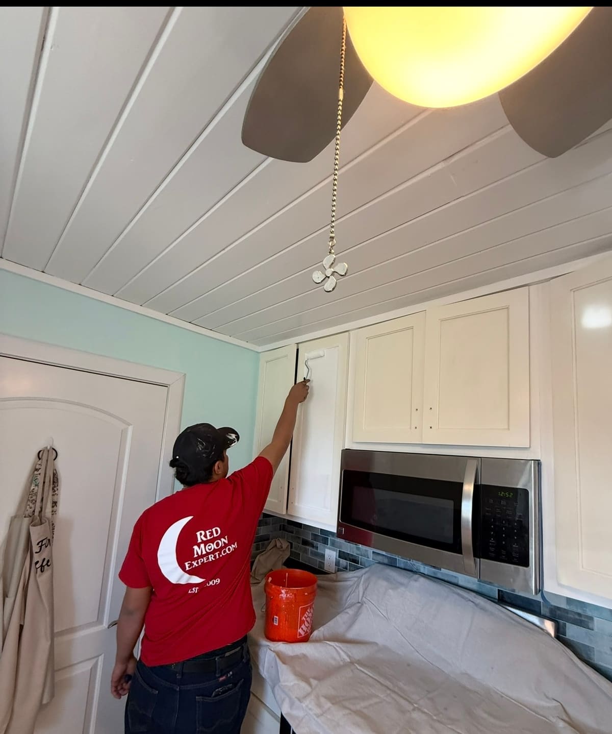 Red Moon Expert crew painting kitchen cabinets — interior painting and finishes