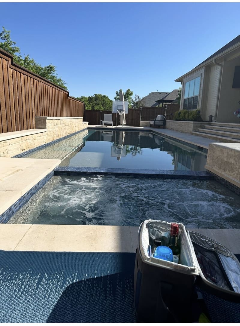 Custom inground pool with spa and cedar privacy fence built by Red Moon Expert