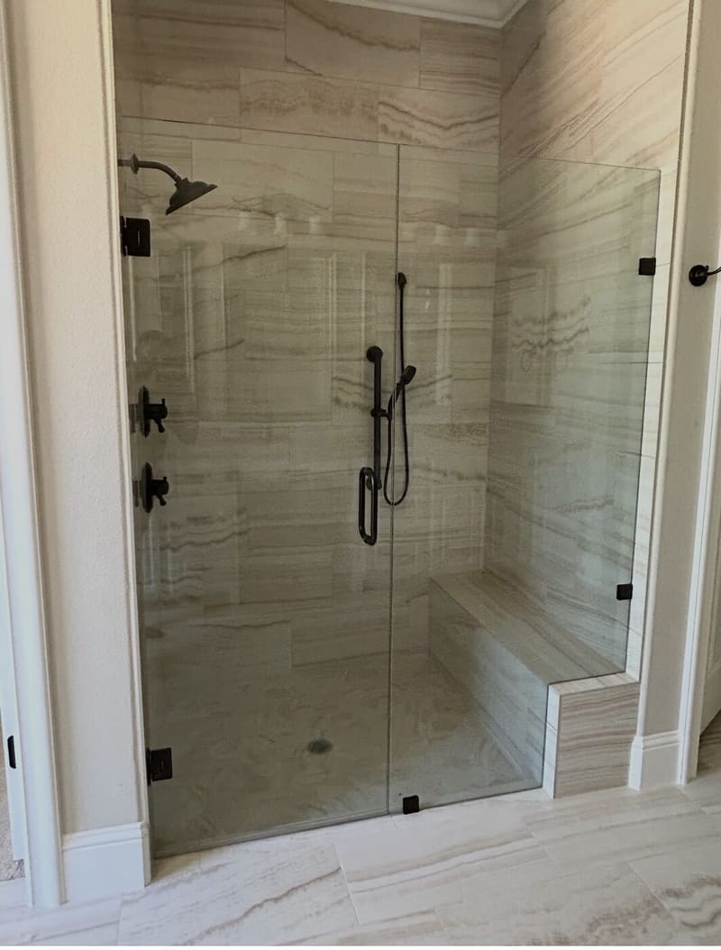 Natural stone walk-in shower with built-in bench seat