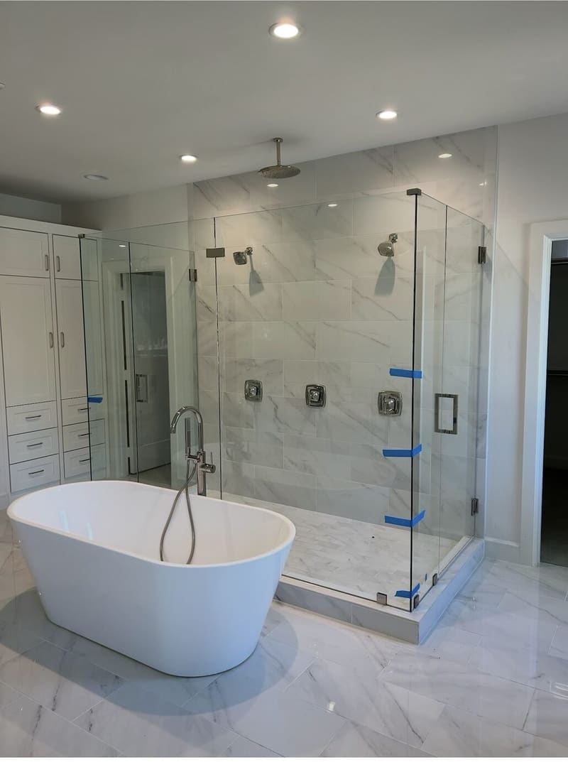 Luxury master bathroom remodel with freestanding soaking tub and frameless glass shower